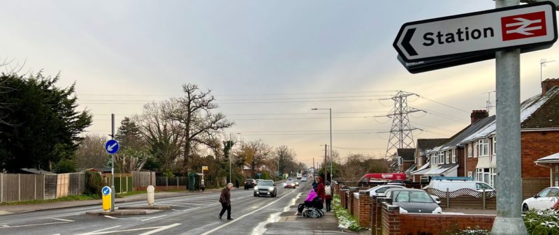 Person crossing Wokingham Road by Earley Rail Station